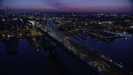 4.8K aerial stock footage flying by Benjamin Franklin Bridge, reveal Downtown Philadelphia skyline, Pennsylvania, Night Aerial Stock Footage | AX81_004