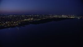 4.8K aerial stock footage of Delaware River and city lights in North Philadelphia, Pennsylvania, Night Aerial Stock Footage | AX81_005