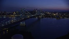 4.8K aerial stock footage approaching Benjamin Franklin Bridge, Delaware River, and Downtown Philadelphia skyline, Pennsylvania, Night Aerial Stock Footage | AX81_007E