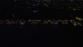 4.8K aerial stock footage of Boathouse Row by the Schuylkill River at night in Philadelphia, Pennsylvania Aerial Stock Footage | AX81_033