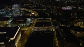 4.8K aerial stock footage of small bridges spanning Schuylkill River by office buildings, approach Philadelphia Museum of Art, Pennsylvania Night Aerial Stock Footage | AX81_071E