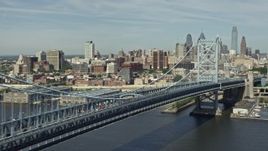 4.8K aerial stock footage panning across Benjamin Franklin Bridge to reveal Downtown Philadelphia skyline, Pennsylvania Aerial Stock Footage | AX82_003E