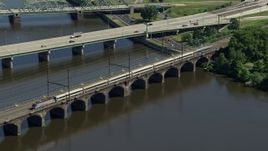 4.8K aerial stock footage of a commuter train crossing the Morrisville-Trenton Railroad Bridge in Trenton, New Jersey Aerial Stock Footage | AX82_060