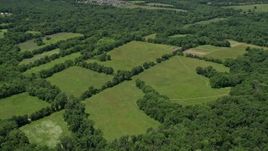4.8K aerial stock footage of green fields bordered by trees, Belle Mead, New Jersey Aerial Stock Footage | AX83_009