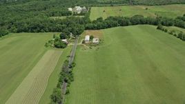 4.8K aerial stock footage flying over fields and barns beside Canal Road in Franklin Park, New Jersey Aerial Stock Footage | AX83_039
