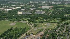 4.8K aerial stock footage flying over baseball fields to approach warehouses and office buildings, Piscataway Township, New Jersey Aerial Stock Footage | AX83_050