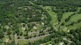 4.8K aerial stock footage flying over suburban neighborhood beside the Ash Brook Golf Course in Edison, New Jersey Aerial Stock Footage | AX83_059E