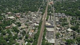 4.8K aerial stock footage of shops and homes around railroad tracks in Cranford, New Jersey Aerial Stock Footage | AX83_065E