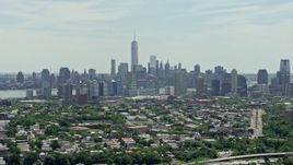 4.8K aerial stock footage of Lower Manhattan skyline behind Downtown Jersey City, New Jersey & New York Aerial Stock Footage | AX83_105