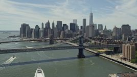 4.8K aerial stock footage fly over Manhattan Bridge to approach Brooklyn Bridge and the Lower Manhattan skyline, New York City Aerial Stock Footage | AX83_183E