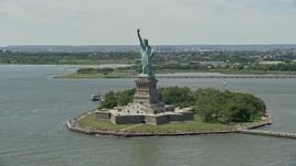 4.8K aerial stock footage flying by Statue of Liberty with tourists in New York Harbor, New York City Aerial Stock Footage | AX83_193