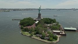 4.8K aerial stock footage orbiting Statue of Liberty with a view of New York Harbor, New York Aerial Stock Footage | AX83_197