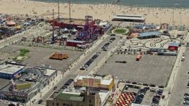 4.8K aerial stock footage orbiting Luna Park and tilt to reveal Original Nathan's Famous Hot Dogs, Coney Island, Brooklyn, New York City Aerial Stock Footage | AX83_218E