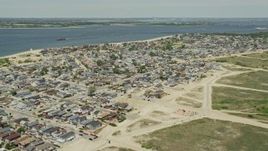 4.8K aerial stock footage flying by residential neighborhoods near the water, Breezy Point, Queens, New York Aerial Stock Footage | AX83_224
