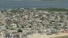 4.8K aerial stock footage of a residential neighborhood near the water, Breezy Point, Queens, New York Aerial Stock Footage | AX83_225