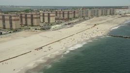 4.8K aerial stock footage of beach goers and apartment complexes, Rockaway Beach, New York  Aerial Stock Footage | AX83_229