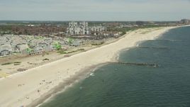4.8K aerial stock footage flying by beachfront condos and sunbathers, Far Rockaway, New York Aerial Stock Footage | AX83_230E