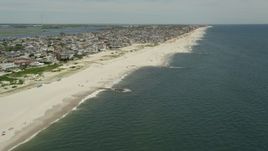 4.8K aerial stock footage of beachgoers and beachfront neighborhoods, Long Beach, New York Aerial Stock Footage | AX83_237