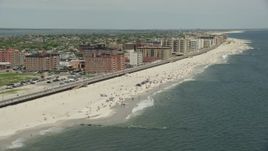 4.8K aerial stock footage tilting to a Crowd of Sunbathers on the Beach, Long Beach, New York Aerial Stock Footage | AX83_241