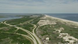 4.8K aerial stock footage flying between coastal road and beach at Jones Beach State Park, Wantagh, New York Aerial Stock Footage | AX83_251