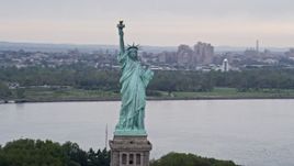 4K aerial stock footage Flying by the Statue of Liberty, New York, New York Aerial Stock Footage | AX84_005