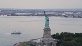 4K aerial stock footage Flying by the Statue of Liberty, New York, New York Aerial Stock Footage | AX84_007