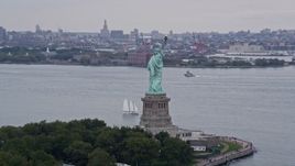 4K aerial stock footage orbiting around the back of the Statue of Liberty, New York, New York Aerial Stock Footage | AX84_011E