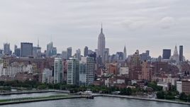 4K aerial stock footage wide view of the Empire State Building and Midtown Manhattan from Hudson River, New York City, New York Aerial Stock Footage | AX84_018E