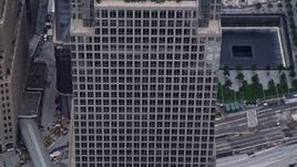4K aerial stock footage tilt down the side of Freedom Tower, reveal the Memorial in Lower Manhattan, New York City Aerial Stock Footage | AX84_091E