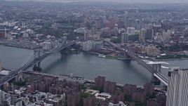 4K aerial stock footage of a view of Manhattan Bridge, Brooklyn Bridge, East River in New York City Aerial Stock Footage | AX84_093E