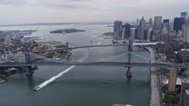 4K aerial stock footage flyby Manhattan Bridge, Brooklyn Bridge over East River, reveal Lower Manhattan, New York City Aerial Stock Footage | AX84_096E