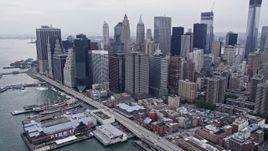 4K aerial stock footage approaching Lower Manhattan skyscrapers by piers along the East River, New York City Aerial Stock Footage | AX84_106E