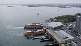 4K aerial stock footage approaching Staten Island Ferries by Lower Manhattan skyscrapers, New York City Aerial Stock Footage | AX84_108E