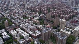 4K aerial stock footage fly over East Village apartment buildings, tilt to reveal Stuyvesant Town and Midtown skyline, New York City Aerial Stock Footage | AX84_129E