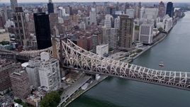 4K aerial stock footage approach the Queensboro Bridge, pan to Midtown skyscrapers in New York City Aerial Stock Footage | AX84_139E