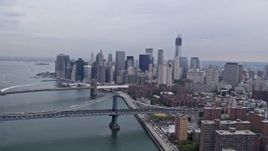4K aerial stock footage tilt from Lower East Side to reveal Lower Manhattan skyline, Brooklyn and Manhattan Bridges, New York City Aerial Stock Footage | AX84_153E
