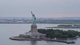 4K aerial stock footage of approaching Statue of Liberty in New York Harbor, New York City Aerial Stock Footage | AX84_163E