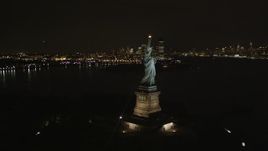 4K aerial stock footage of flying by Statue of Liberty, New York, New York, night Aerial Stock Footage | AX85_004