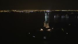 4K aerial stock footage Orbiting the Statue of Liberty, New York, New York, night Aerial Stock Footage | AX85_007