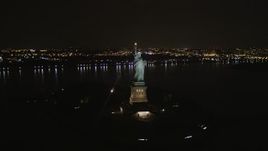 4K aerial stock footage Orbiting the front of the Statue of Liberty, New York, New York, night Aerial Stock Footage | AX85_008