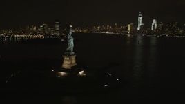 4K aerial stock footage of Statue of Liberty, Lower Manhattan skyline, New York, New York, night Aerial Stock Footage | AX85_009