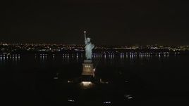 4K aerial stock footage Flying away from the Statue of Liberty, New York, New York, night Aerial Stock Footage | AX85_011
