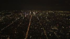 4K aerial stock footage Tilting up from Soho, revealing Midtown Manhattan, New York, New York, night Aerial Stock Footage | AX85_031