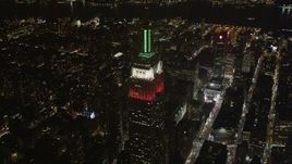 4K aerial stock footage Flying by the Empire State Building, Midtown Manhattan, New York, New York, night Aerial Stock Footage | AX85_052