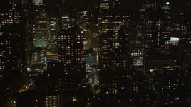 Flying by Lower Manhattan skyscrapers, New York, New York, night Aerial Stock Footage | AX85_123