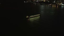 4K aerial stock footage Fly by Staten Island Ferry, reveal Lower Manhattan, New York, New York, night Aerial Stock Footage | AX85_125