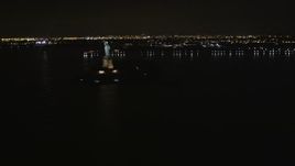 4K aerial stock footage Approaching the Statue of Liberty, New York, New York, night Aerial Stock Footage | AX85_134