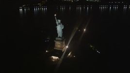 4K aerial stock footage Approaching the Statue of Liberty, tilt down, New York, New York, night Aerial Stock Footage | AX85_135