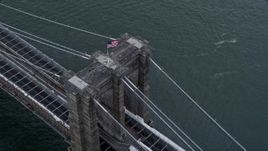 4K aerial stock footage of orbiting the American flag atop the Brooklyn Bridge, New York City Aerial Stock Footage | AX86_024