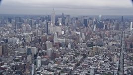 4K aerial stock footage tilt from Lower East Side to reveal the Empire State Building and Midtown Manhattan, New York City Aerial Stock Footage | AX86_027